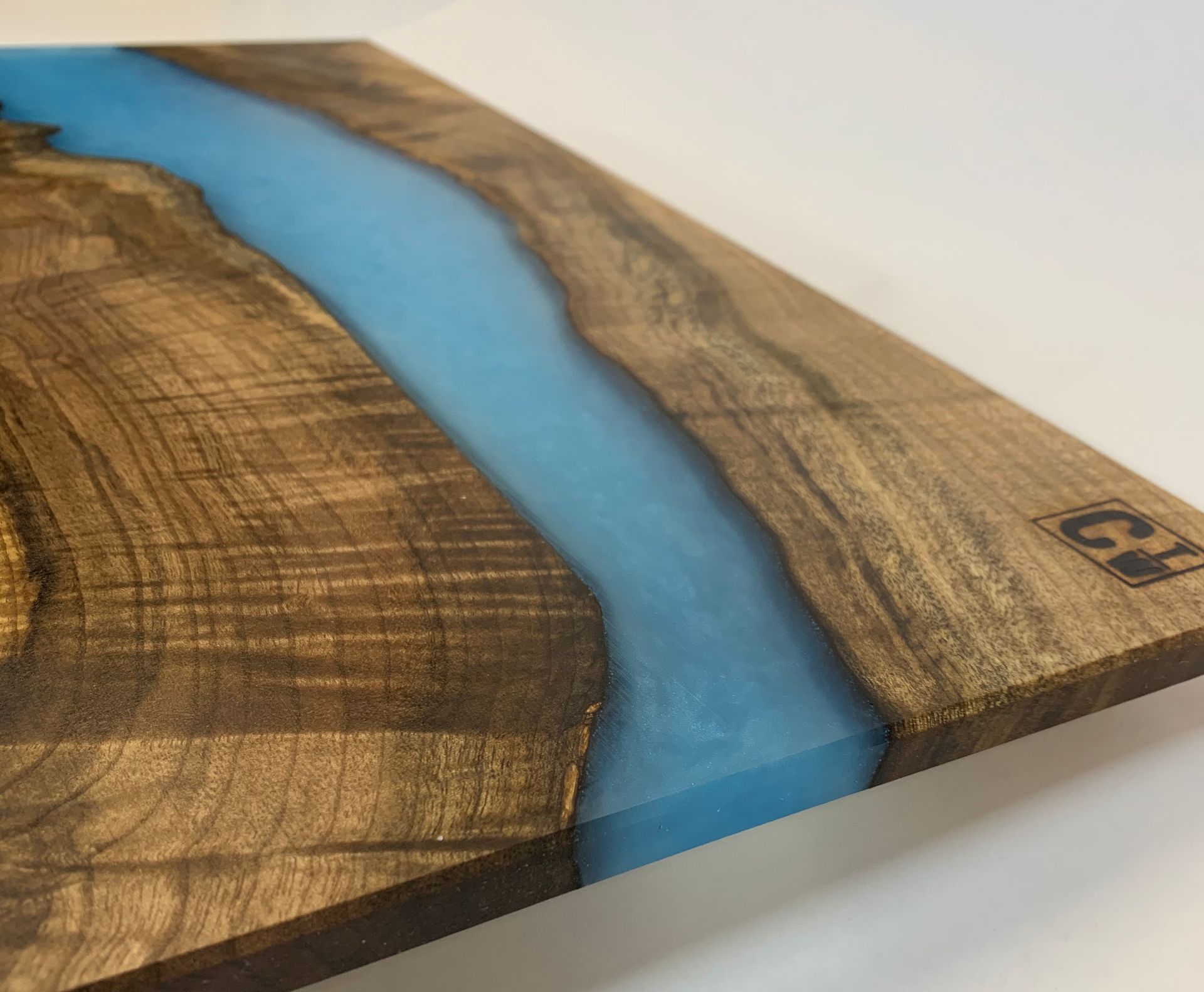 A piece of wood with a blue river running through it