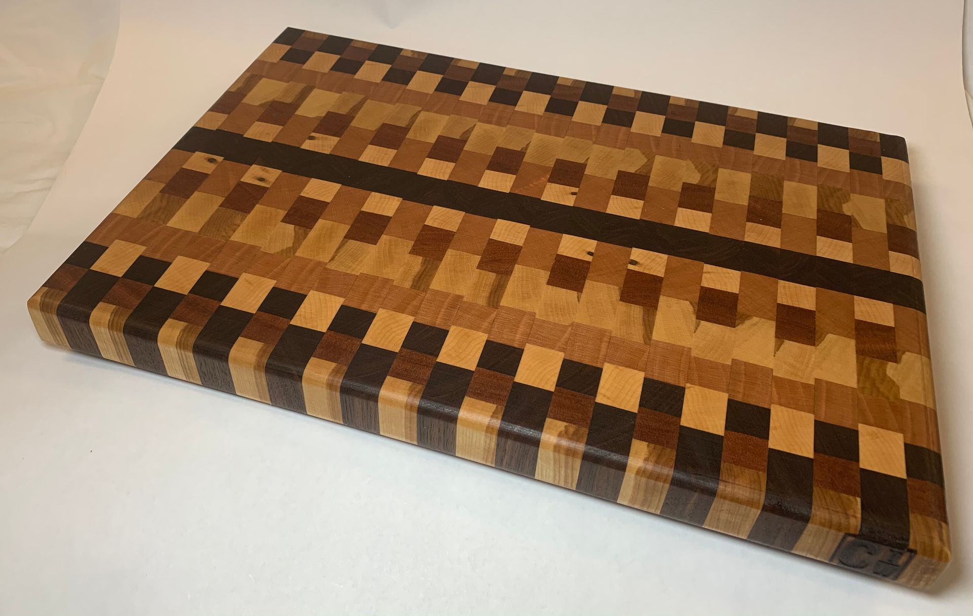 A wooden cutting board with a checkered pattern on it