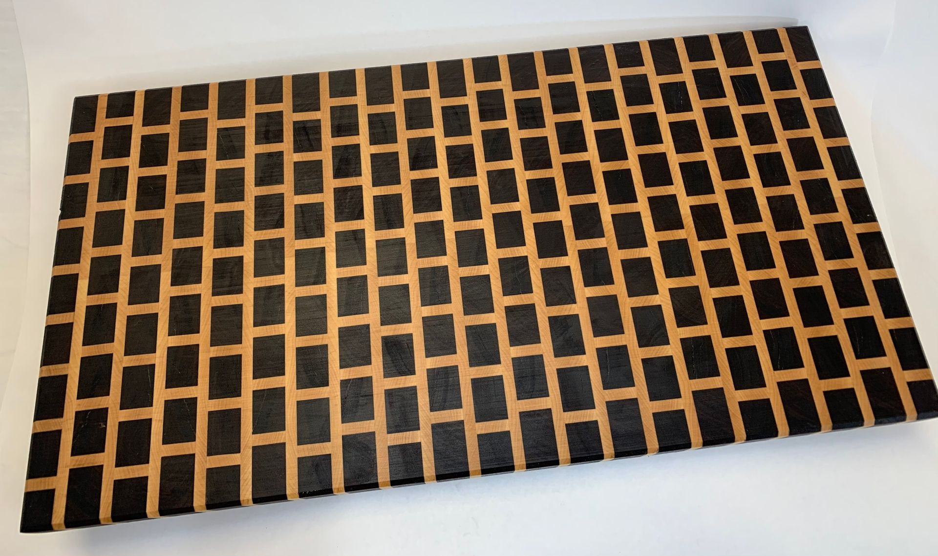A black and brown rug with squares on it