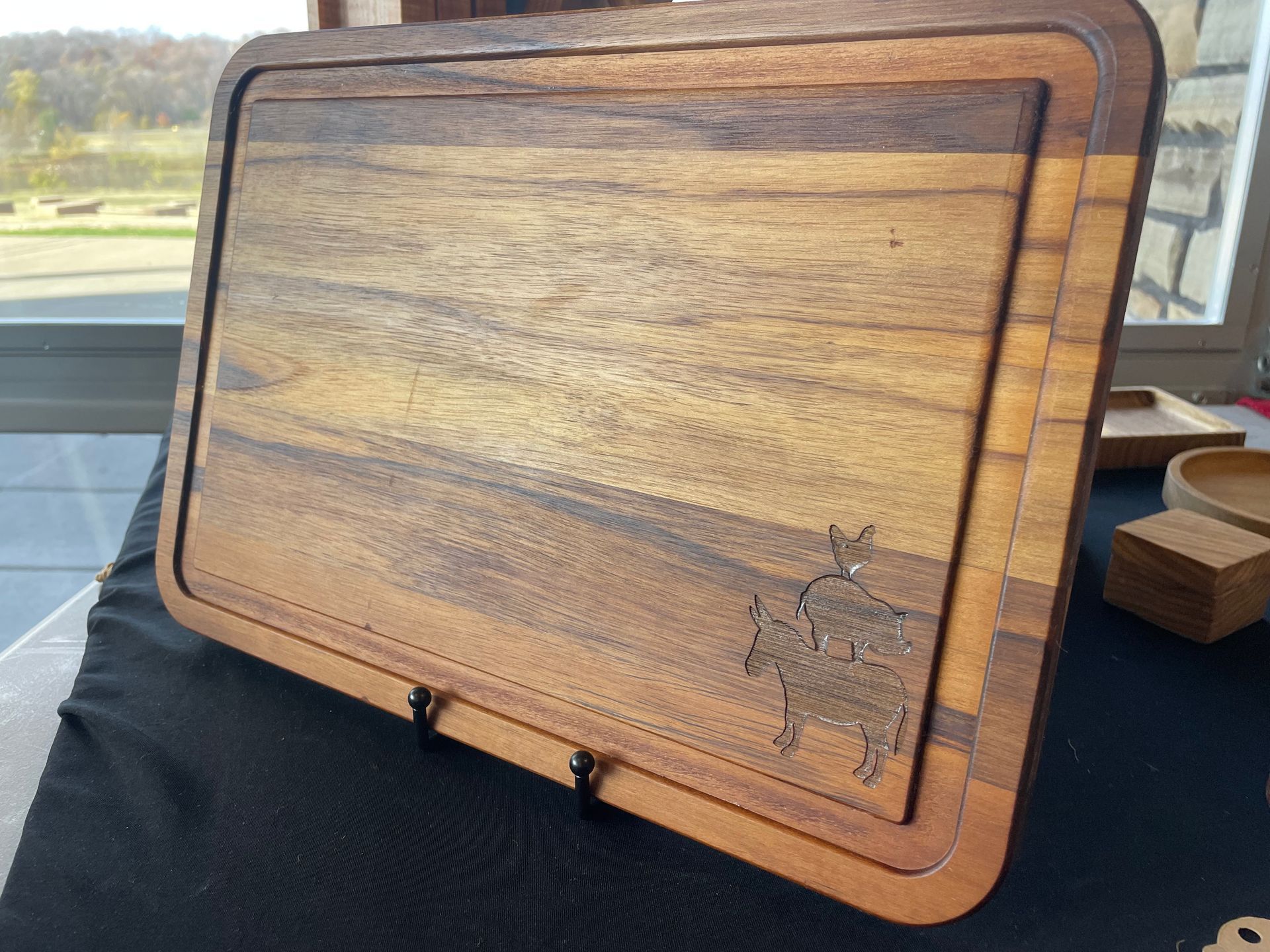 A wooden cutting board with a picture of a deer on it
