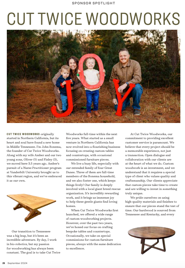A family is standing next to each other in a forest holding letters j and y.