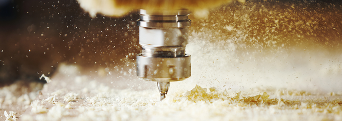 A close up of a machine cutting a piece of wood.