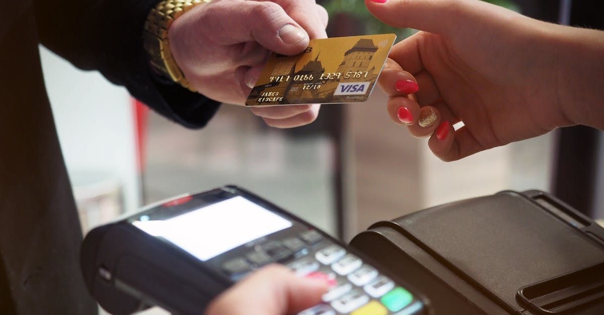 A woman is using a credit card to pay for something.