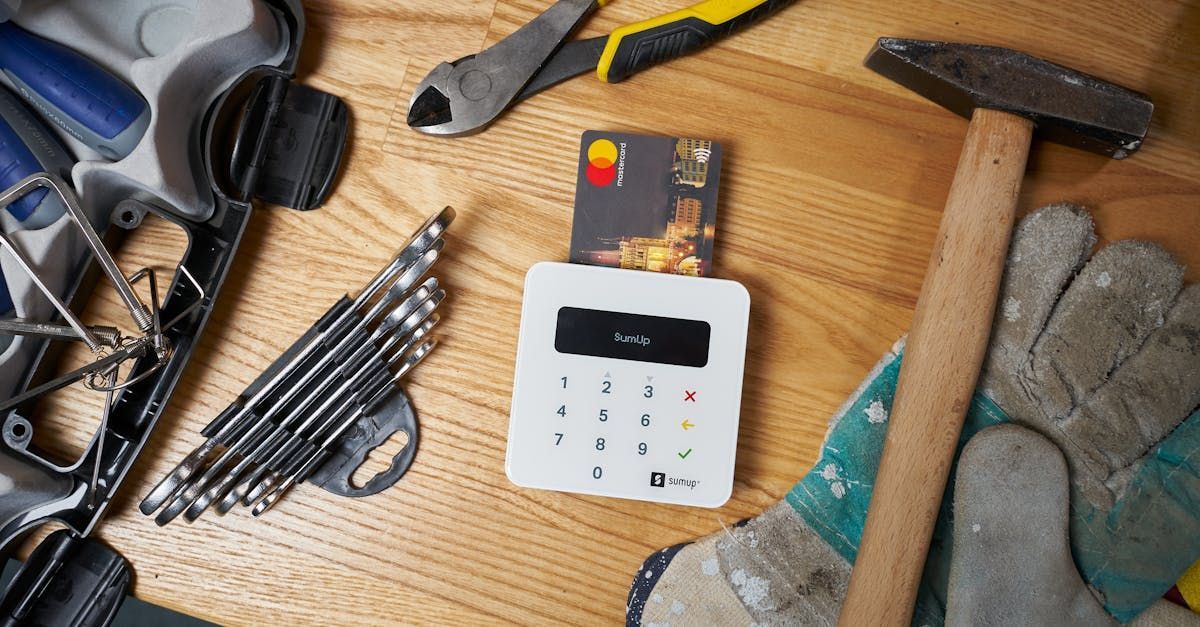 A credit card is sitting on top of a wooden table surrounded by tools.