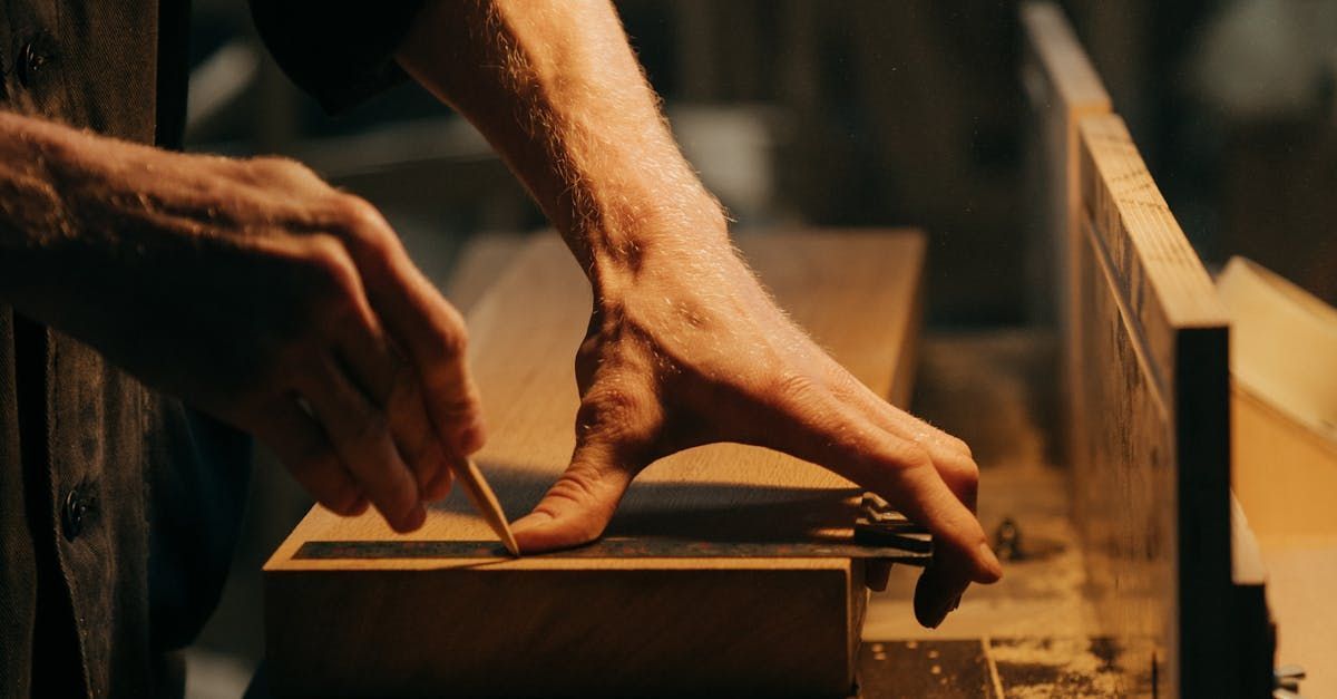 A man is cutting a piece of wood with a circular saw.