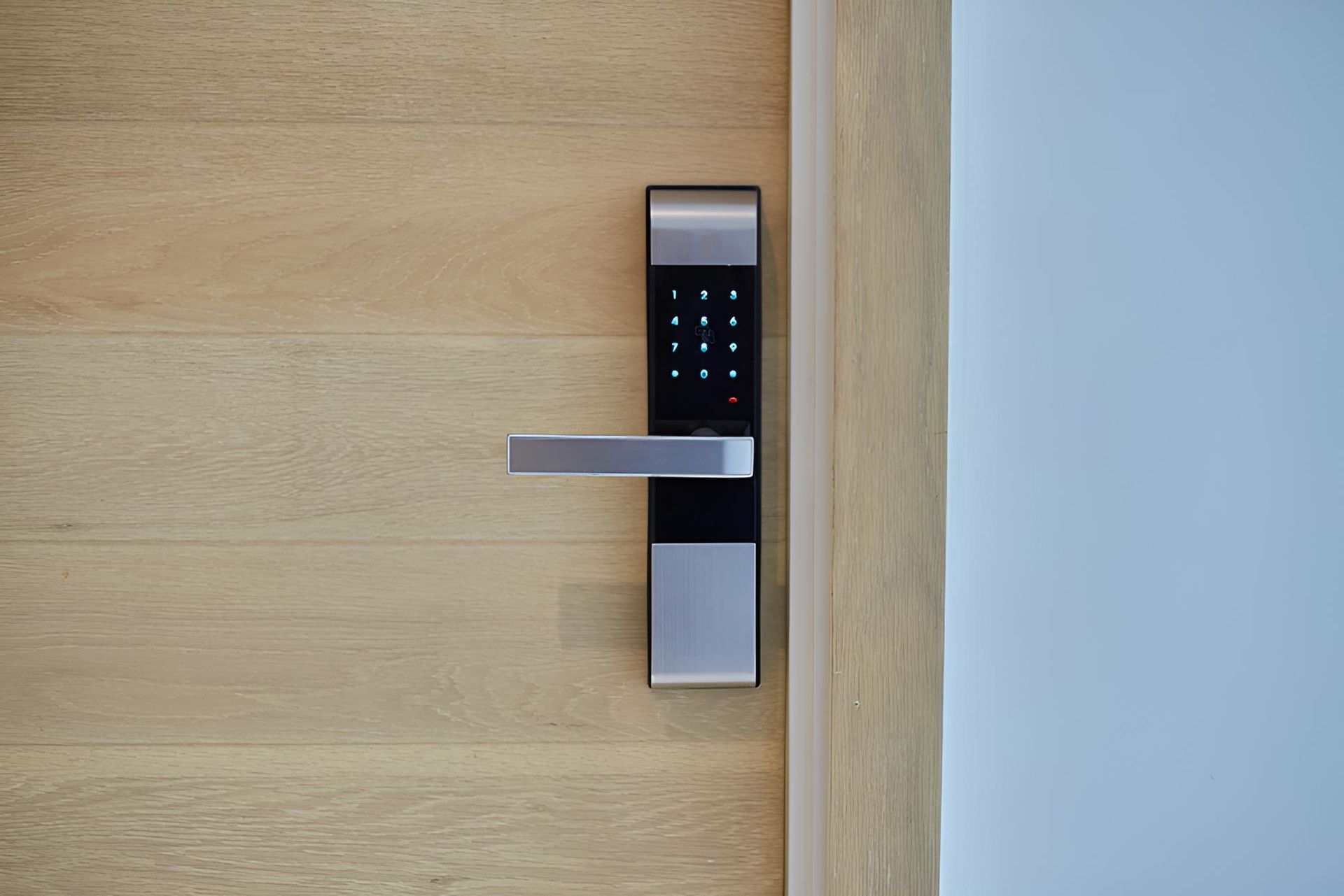 Digital Door Lock With Keypad And Lever On A Wooden Door, Next To A White Wall — Coffs City Lockmart Pty Ltd in North Boambee Valley, NSW