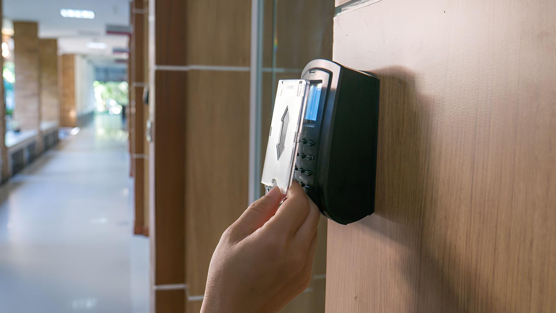 Person Swipes an Access Card on a Black Card Reader — Coffs City Lockmart Pty Ltd in North Boambee Valley, NSW