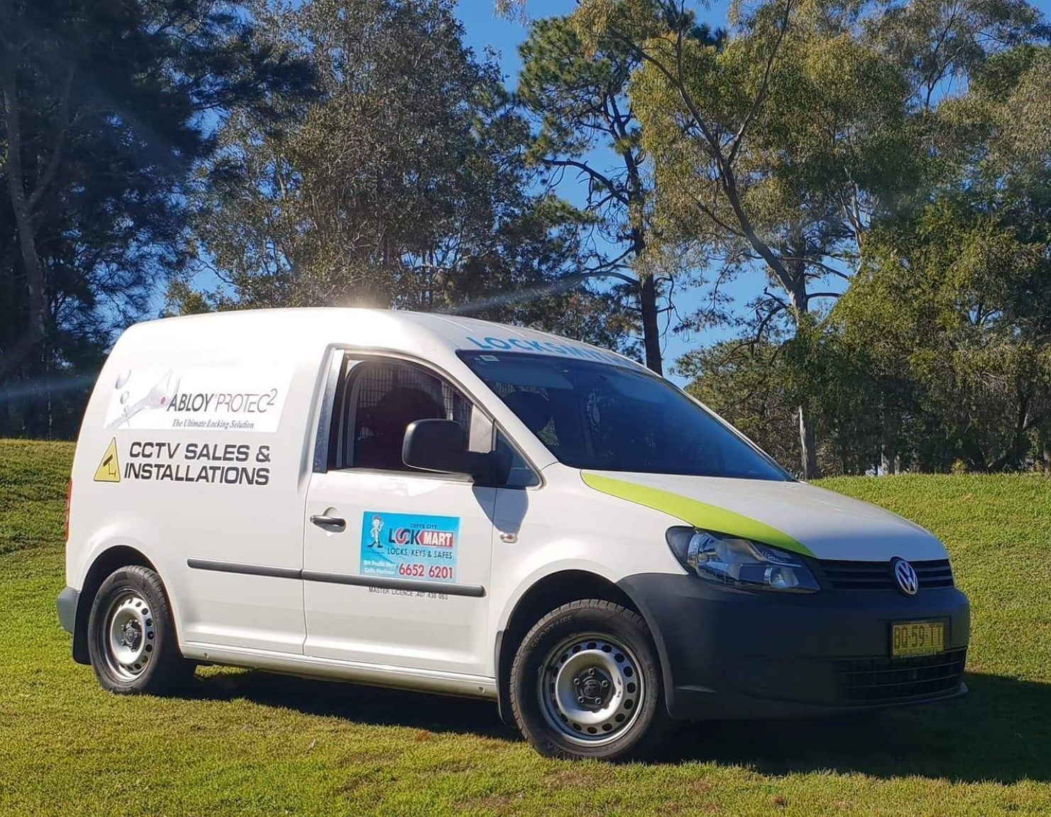 A company van is parked on a lawn