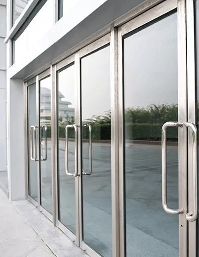 A Row of Glass Doors with Stainless Steel Handles on A Building — Coffs City Lockmart Pty Ltd in North Boambee Valley, NSW