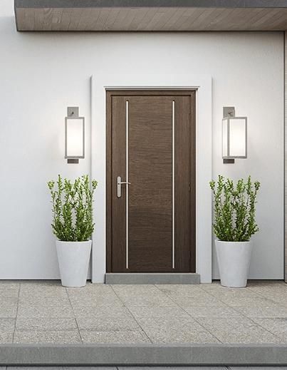 A Brown Door with Two Potted Plants in Front of It — Coffs City Lockmart Pty Ltd in North Boambee Valley, NSW