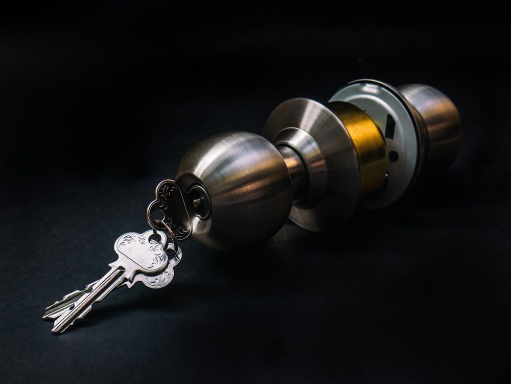 A Stainless Steel Door Knob With a Bunch of Keys in It — Coffs City Lockmart Pty Ltd in Grafton, NSW