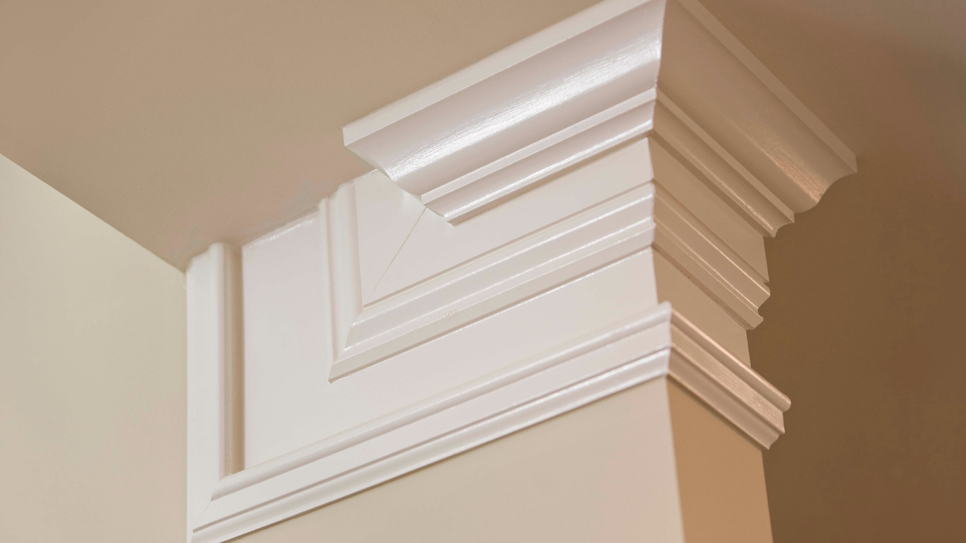 White painted decorative molding at a wall corner.