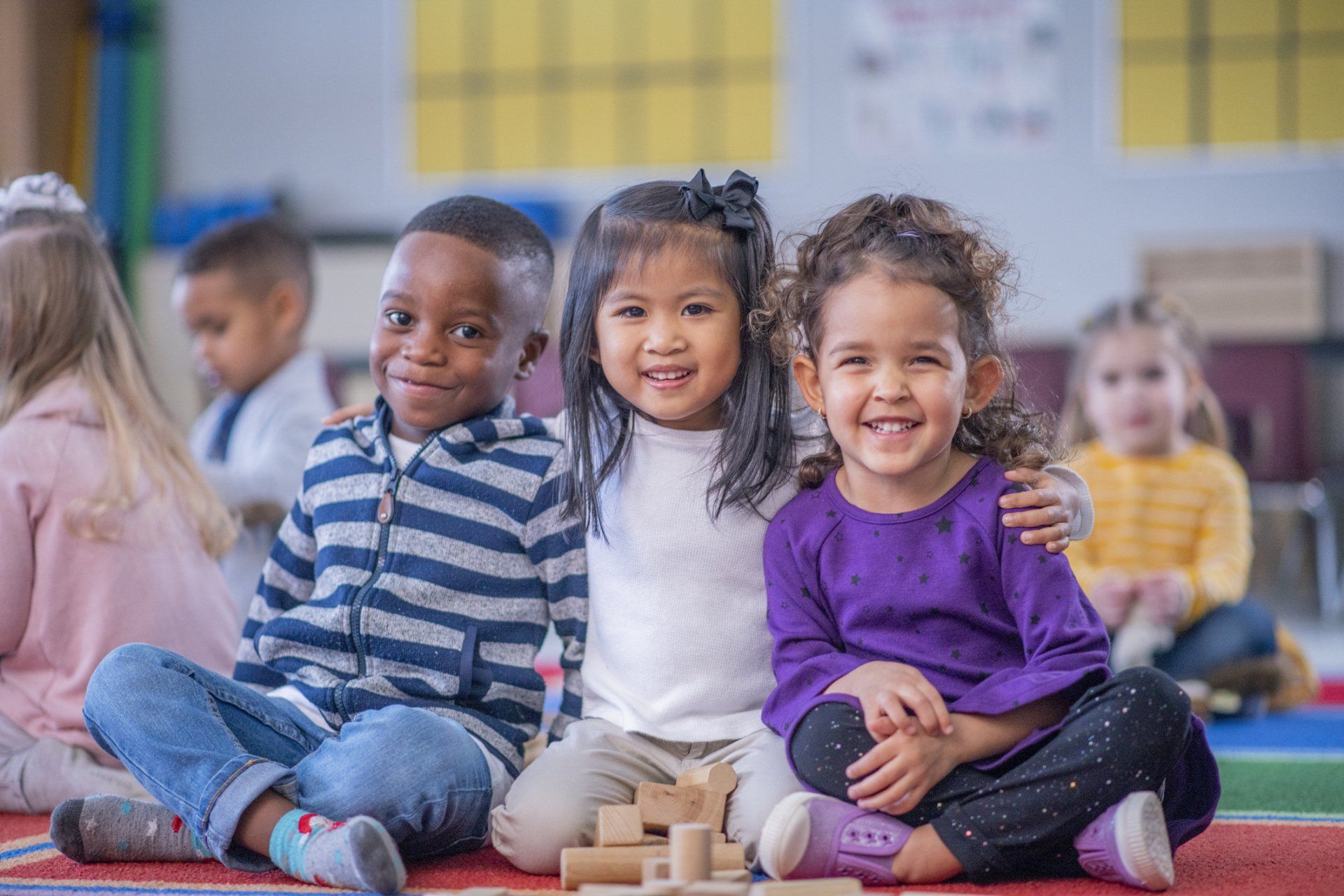 Three kids smiling — Bronx, NY — A Continuation of a Dream Daycare Center