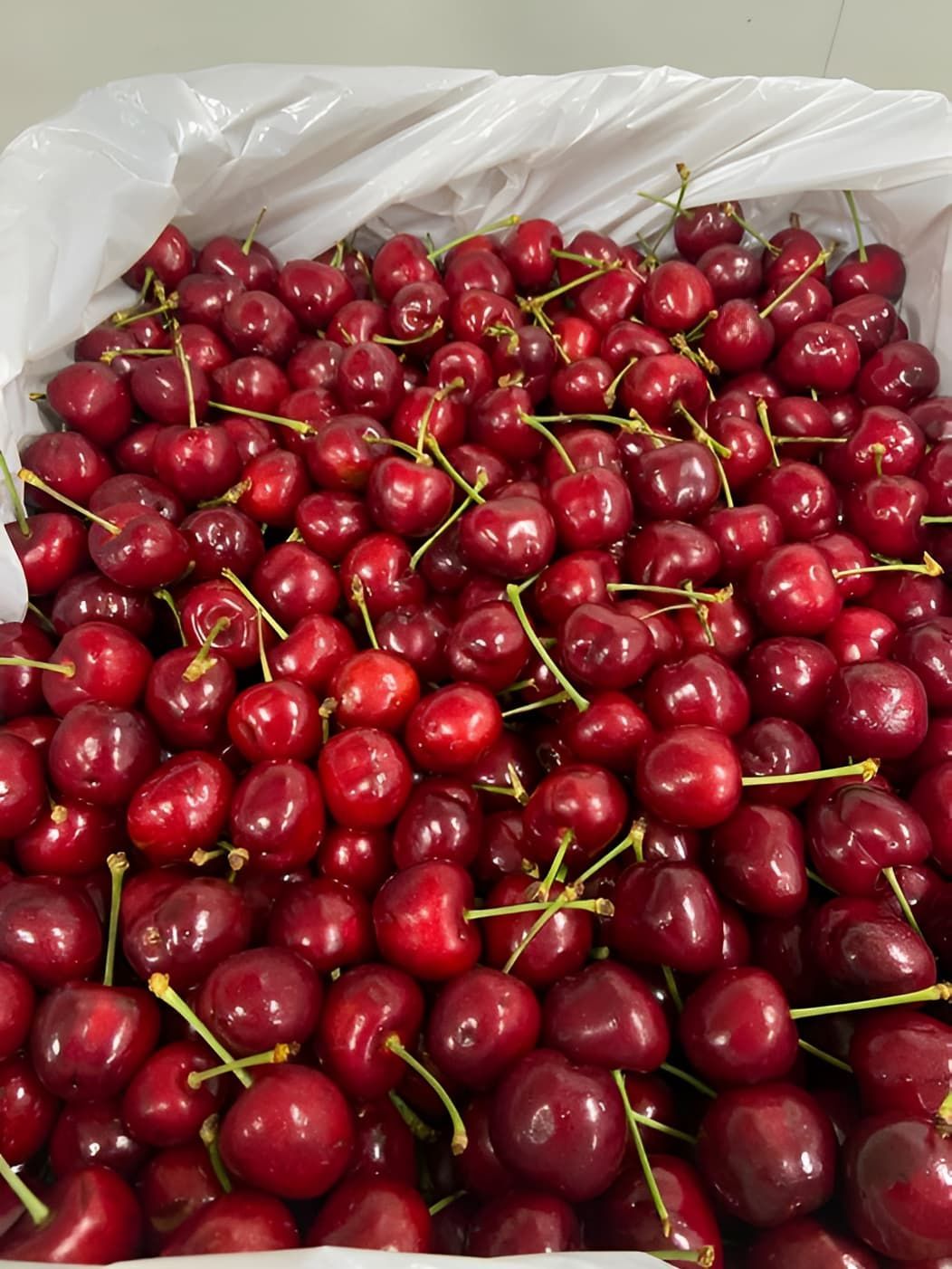 A Bunch Of Cherries Are In A White Bag — Central Fruit & Vegetable Wholesalers Pty Ltd In Alice Springs, NT