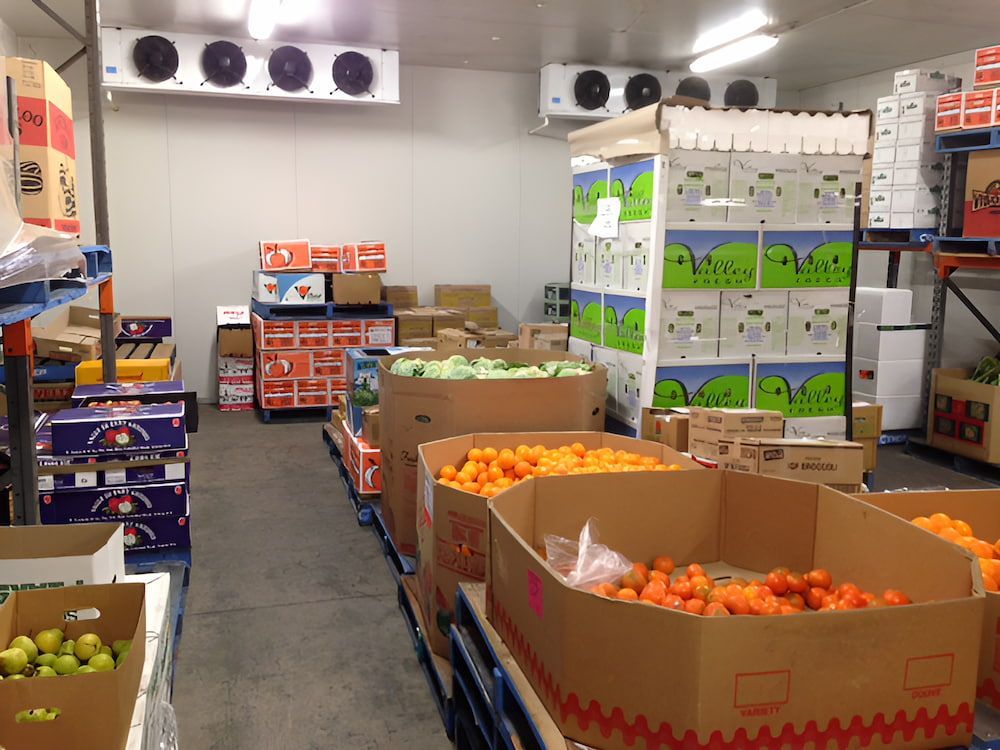 A Warehouse Filled With Lots Of Boxes Of Fruit And Vegetables — Central Fruit & Vegetable Wholesalers Pty Ltd In Alice Springs, NT