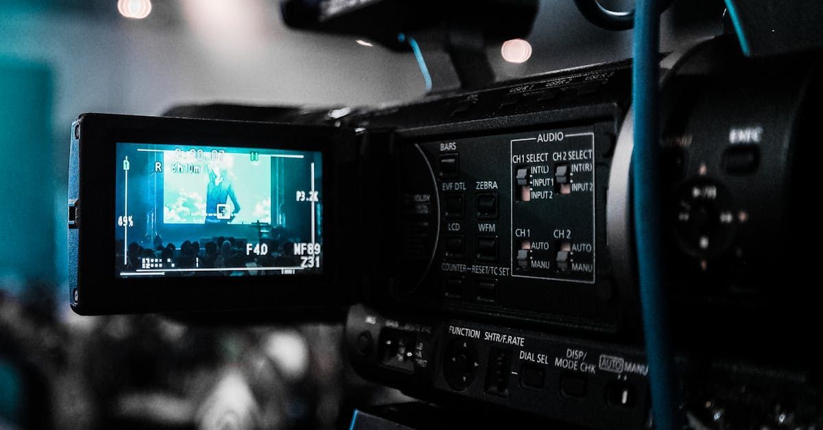 A close up of a video camera with a blue cable attached to it.