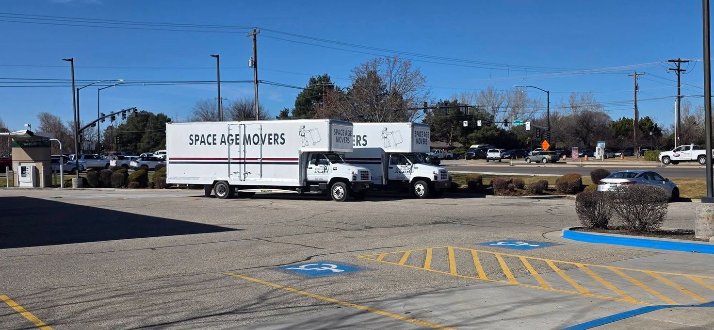 White truck trailer at a parking lot with blue handicap space markings and a road in the background