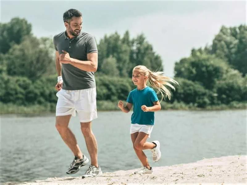 Man and a Little Girl Are Running on the Beach — Mullumbimby Comprehensive Health Centre in Mullumbimby, NSW