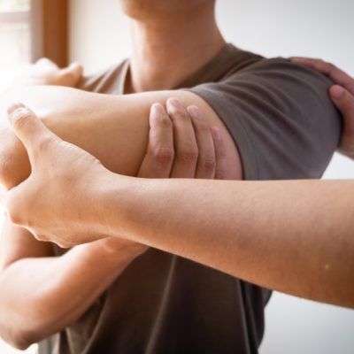 Man is Getting a Massage From a Woman — Mullumbimby Comprehensive Health Centre in Mullumbimby, NSW