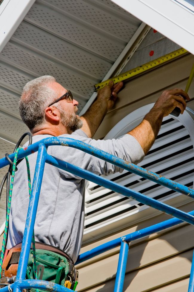 Siding installation professional measuring