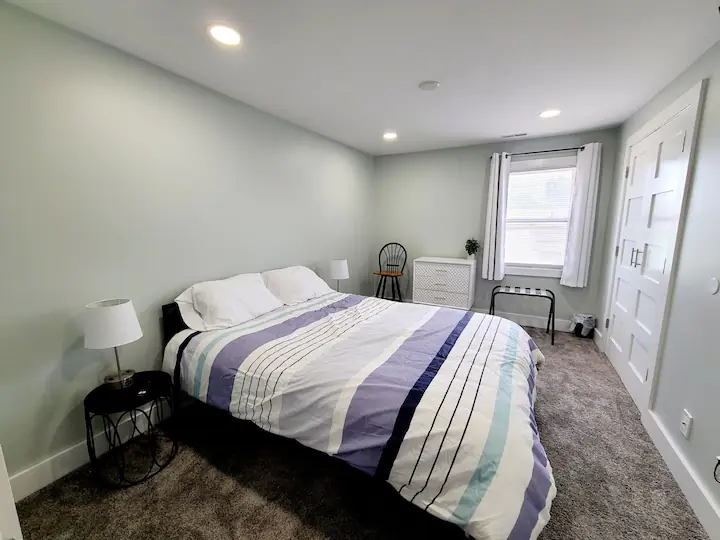 A bedroom with a large bed and a window