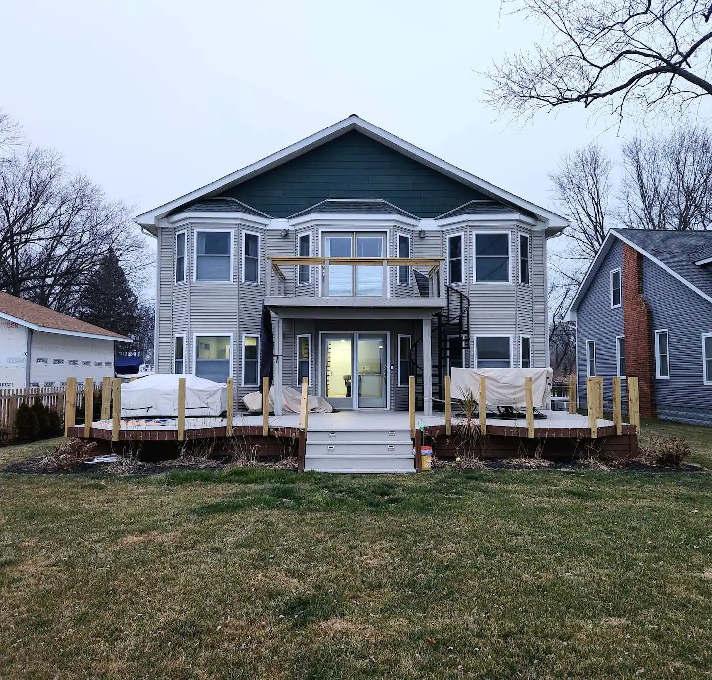 The back of a house with a deck and stairs.