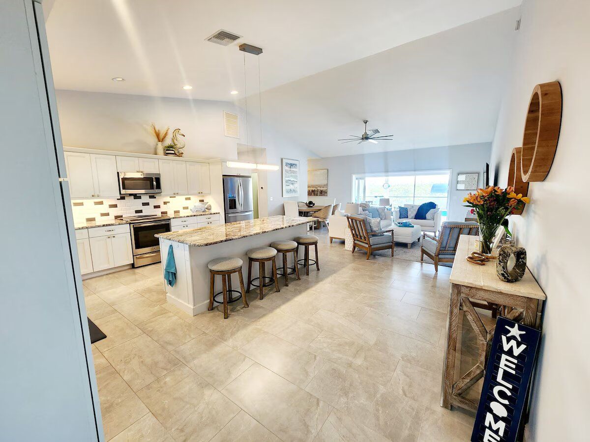 A large room with a kitchen , living room , and dining room.