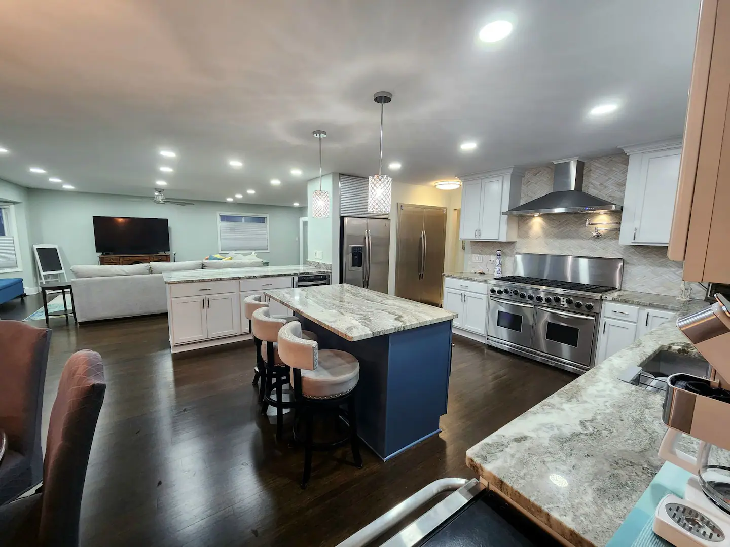 A kitchen with large appliances in the middle of it