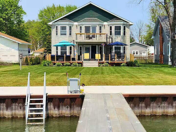 A large house with a dock in front of it.