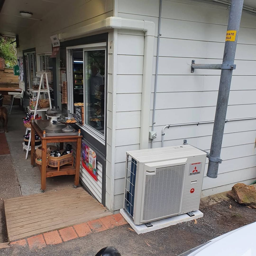 A Small Shop With a Stainless Steel Counter and an Air Conditioning Unit — Bay & Basin Air Conditioning & Refrigeration Pty Ltd in St Georges Basin, NSW