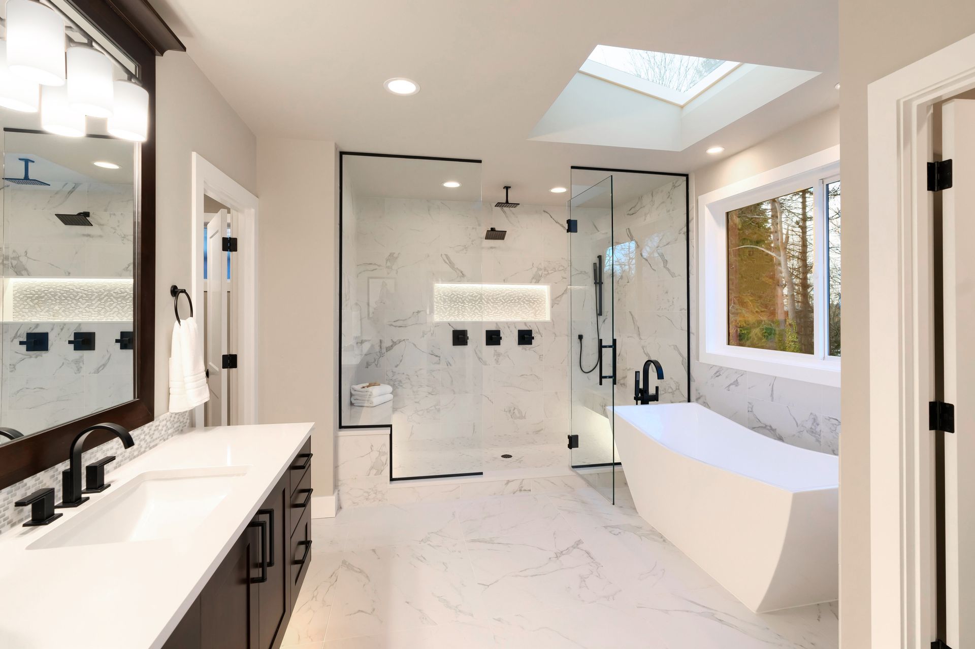 Modern bathroom with a large shower, soaking tub, and double vanity.