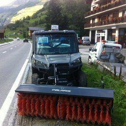 Un véhicule utilitaire Polaris est garé sur le bord de la route.