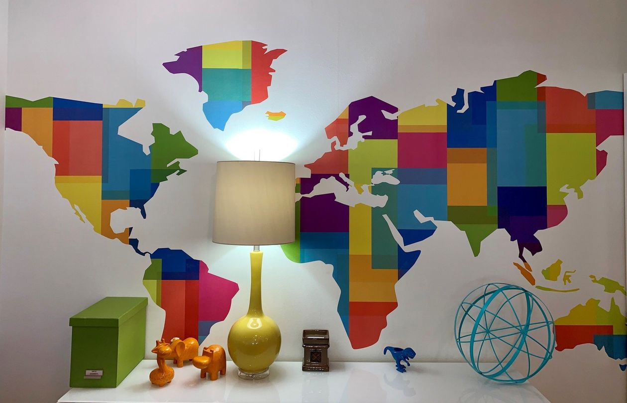 A colorful map of the world is painted on a wall