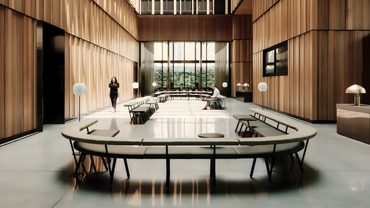 Modern conference room with a long table, wood-paneled walls, and floor-to-ceiling windows overlooking greenery