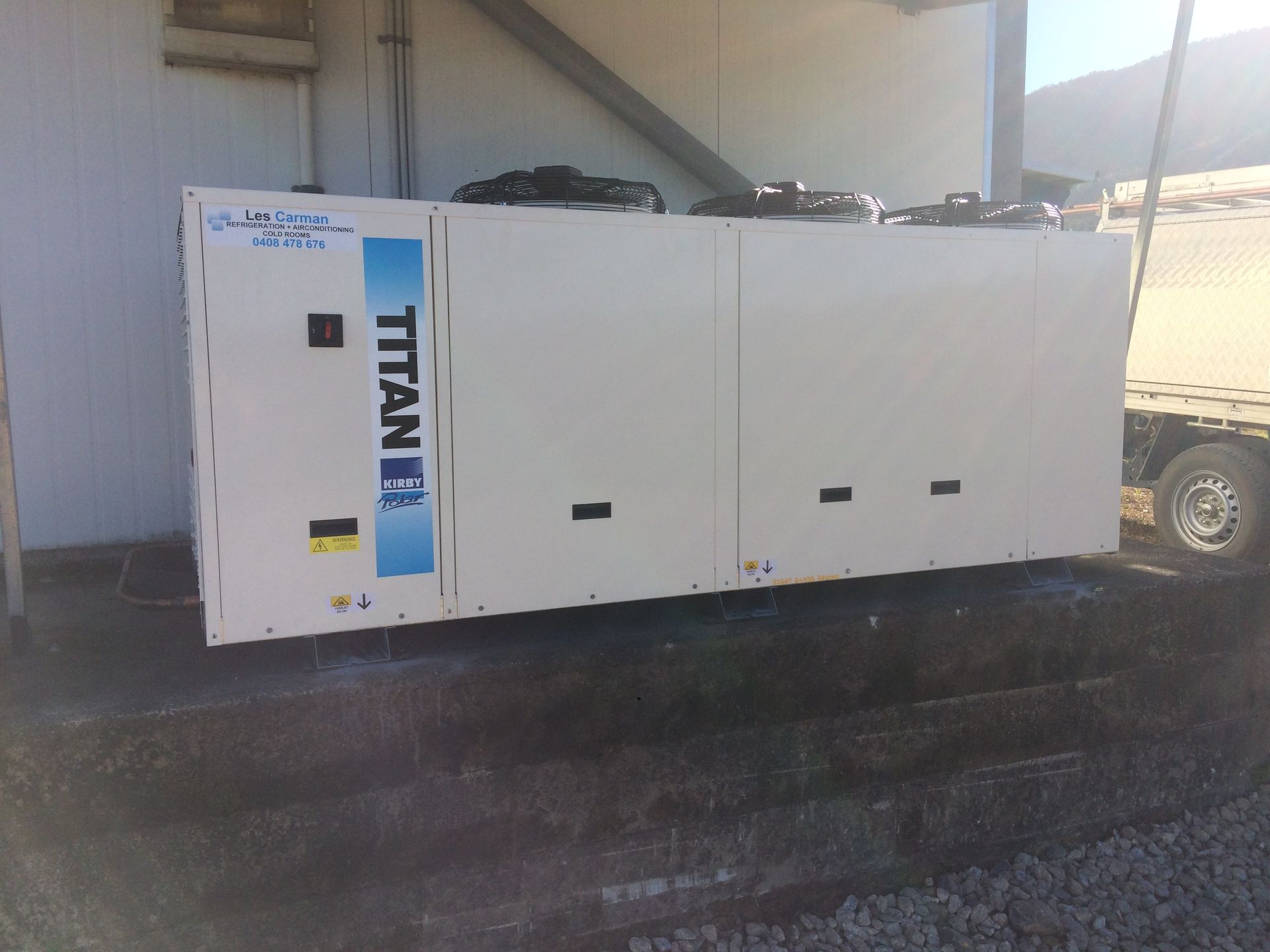 Hand Opening a Stainless Steel Refrigerator Door — Les Carman Cooling Solutions in El Arish, QLD