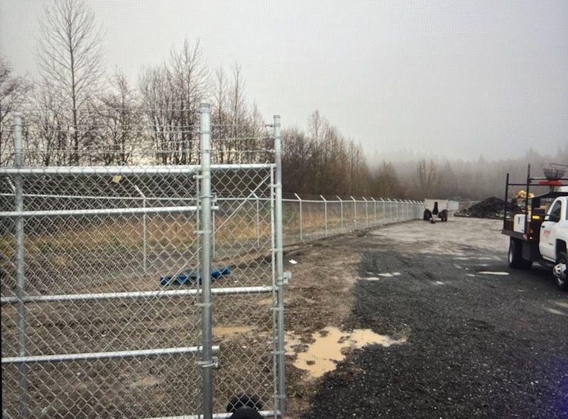 A Chain Link Fence with A Truck Parked Behind It - Sequim, WA- NW Chainlink Fence Co