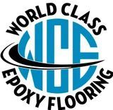 Logo for World Class Epoxy Flooring, featuring blue circle, black swoosh, and text.