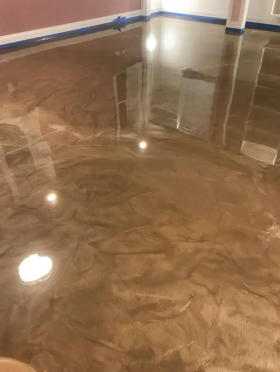 Metallic gold epoxy floor, reflecting light and the surrounding room.