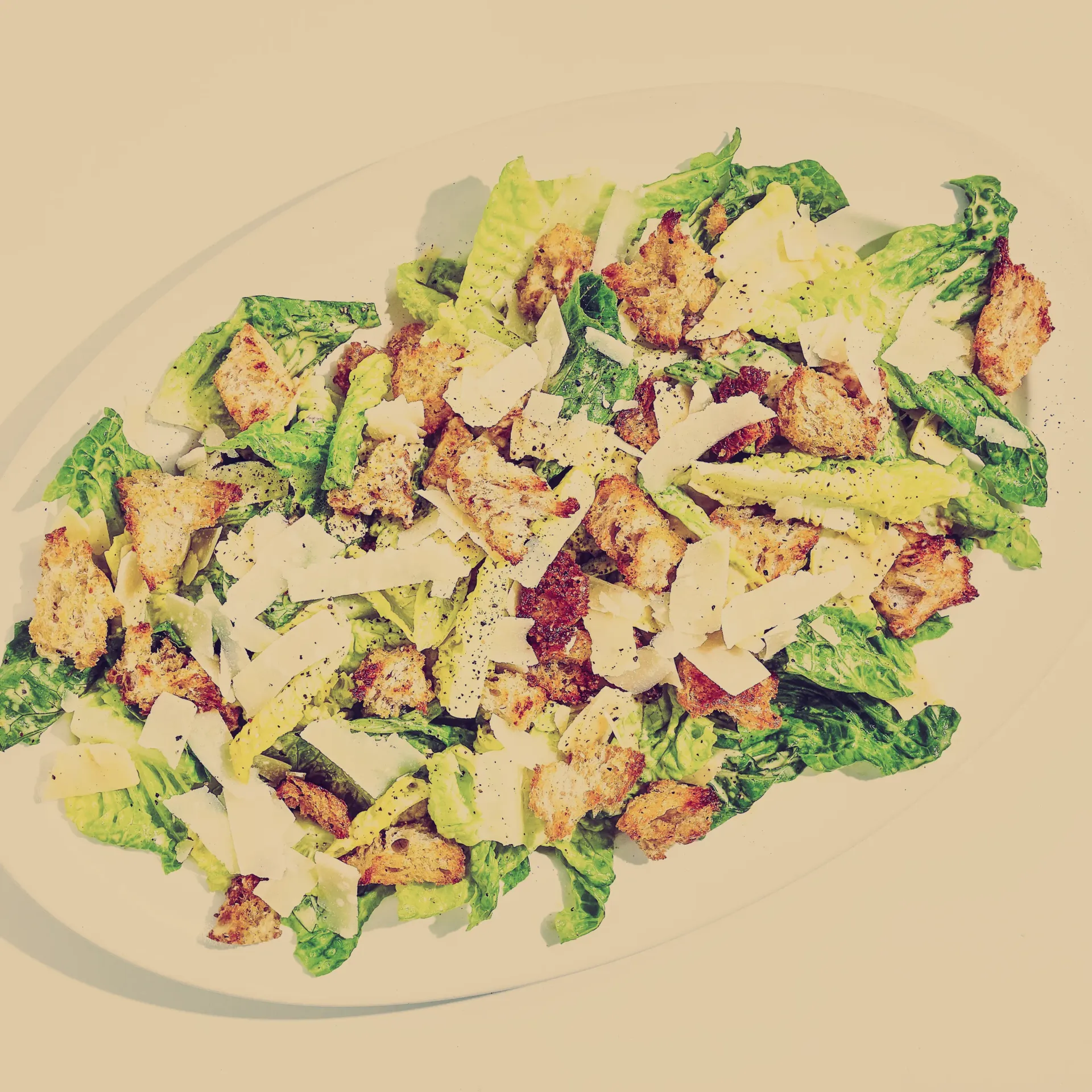 A close up of a caesar salad on a plate