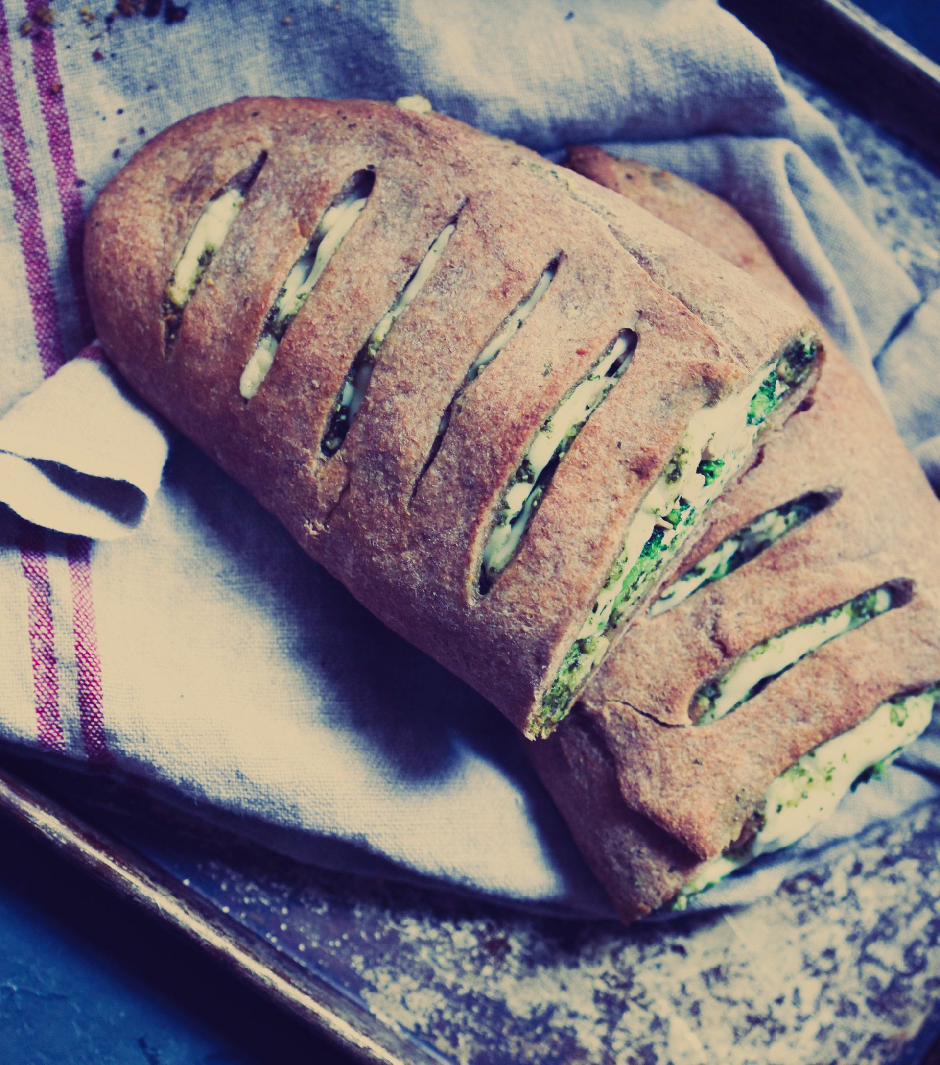 A loaf of bread is sitting on a towel on a tray