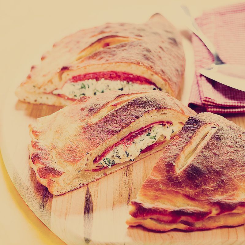 A close up of a sandwich on a cutting board