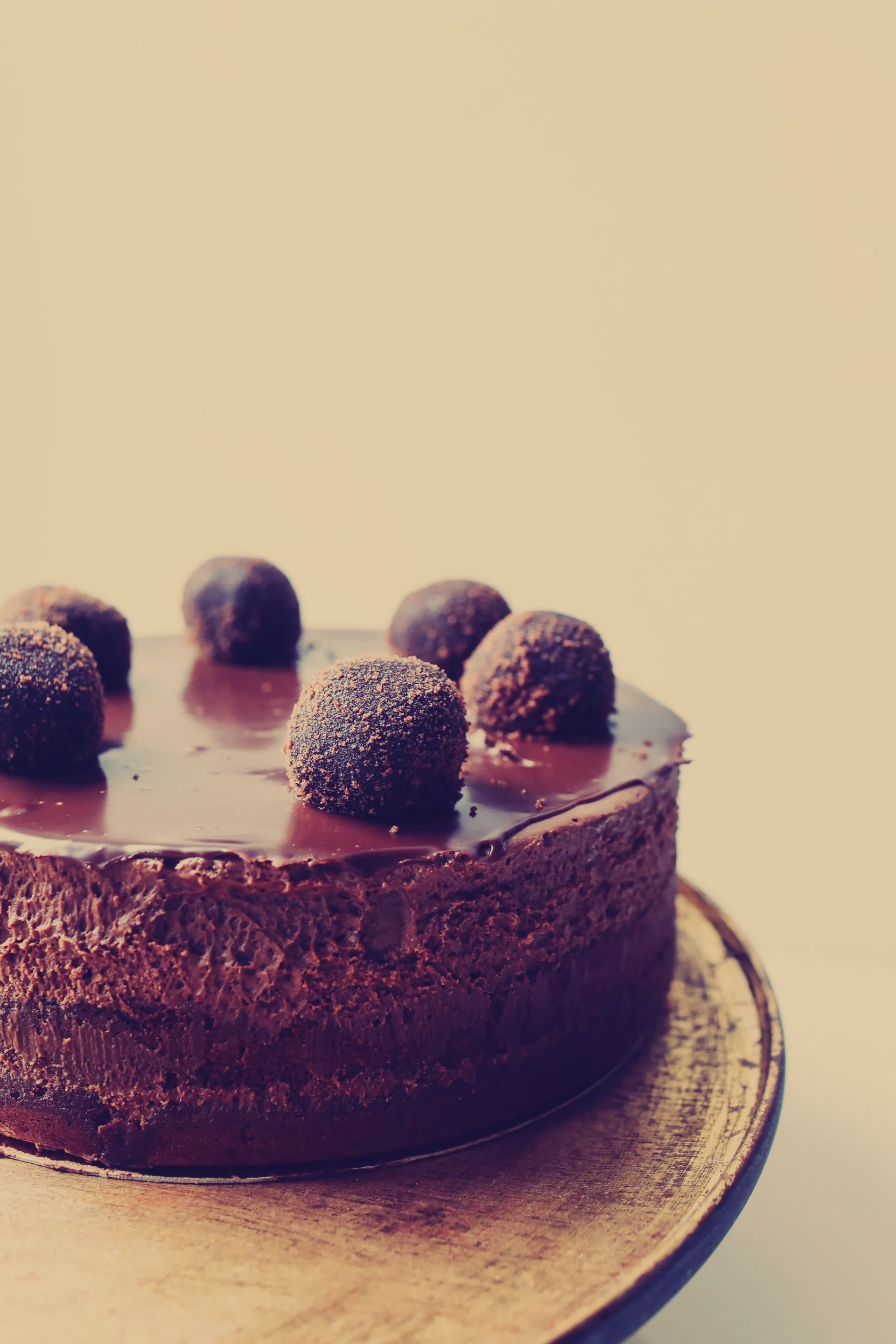 A chocolate cake with chocolate balls on top of it