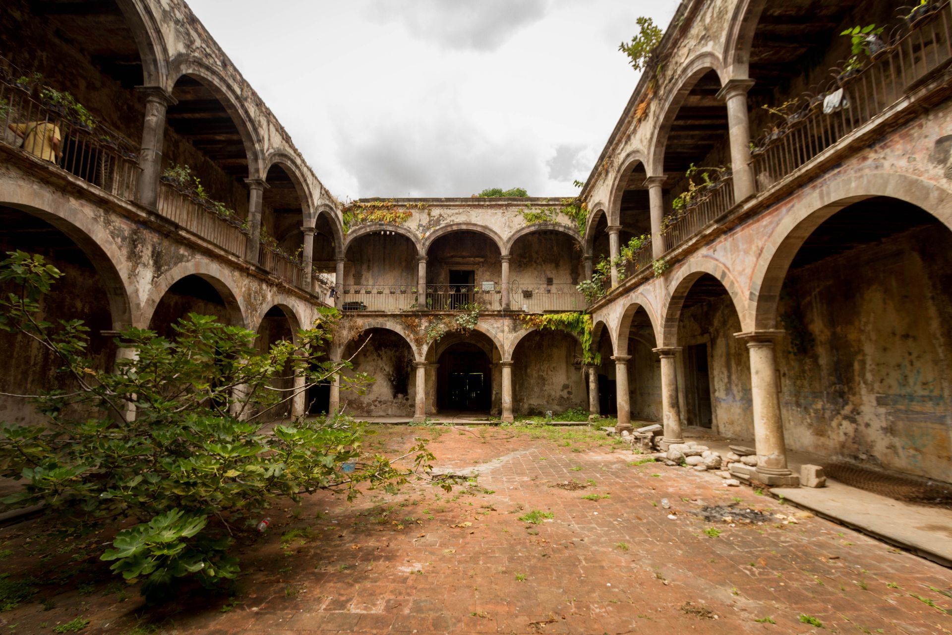 Un patio de un edificio antiguo con arcos y balcones.