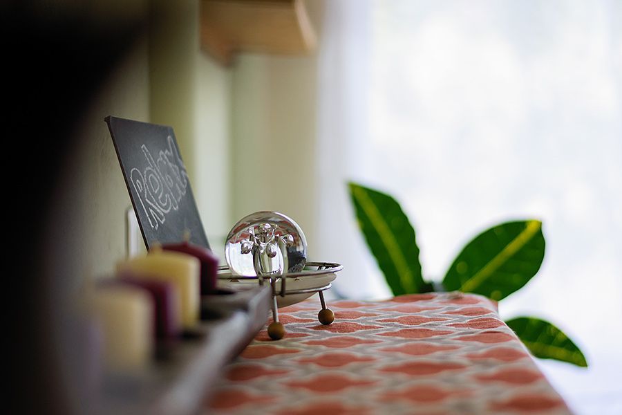 Una mesa con una bandeja de velas y un cartel sobre ella.