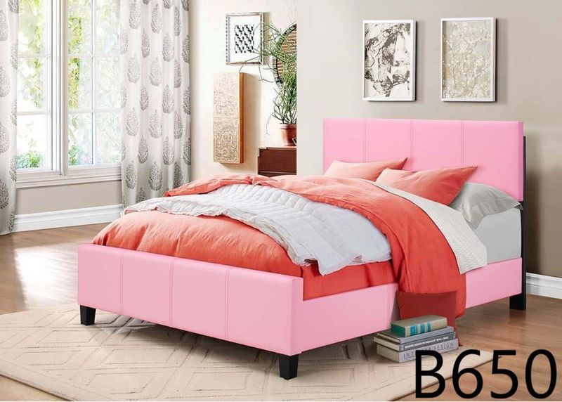 A bedroom with a pink bed and a pink headboard