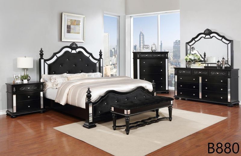 A bedroom with a bed , dresser , nightstand , mirror and bench.