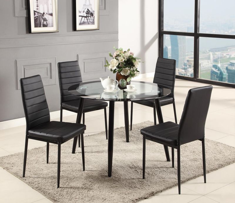 A dining room with a glass table and black chairs
