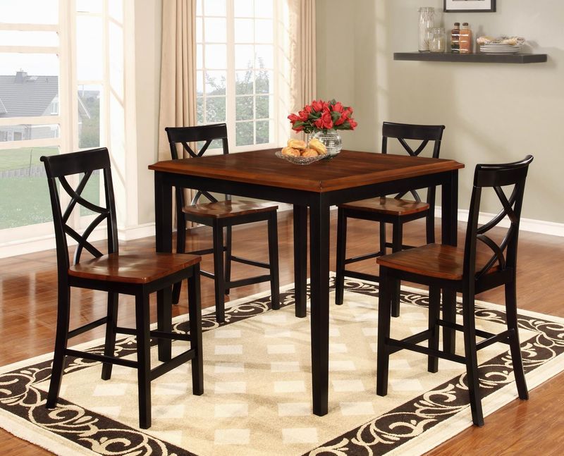 A dining room with a table and chairs and a rug