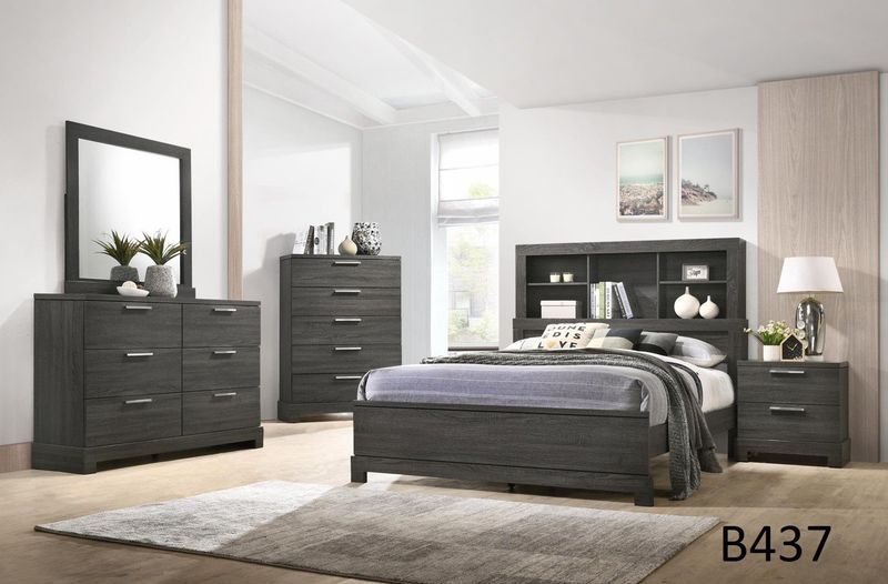 A bedroom with a bed , dresser , nightstand , mirror and rug.