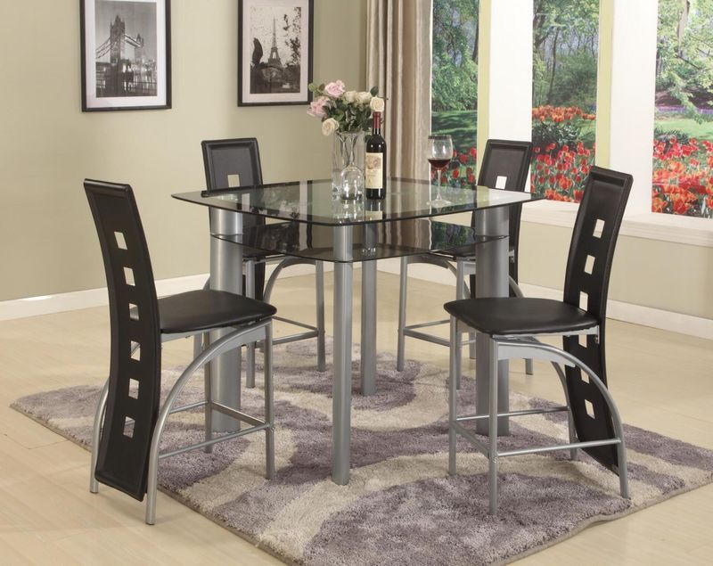 A dining room with a glass table and black chairs